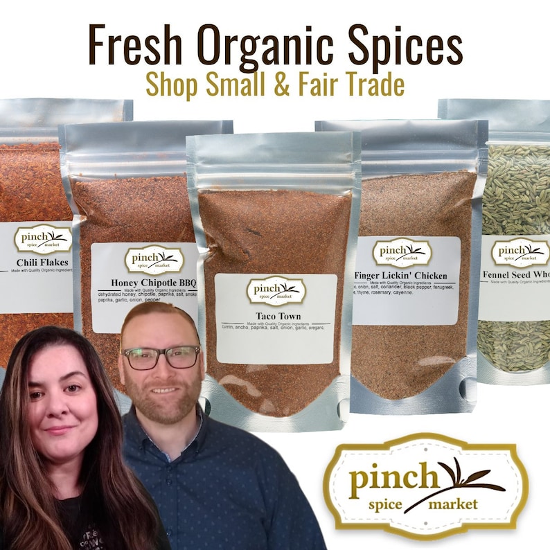 May include: Five silver stand-up pouches filled with organic spices labeled Chili Flakes, Honey Chipotle BBQ, Taco Town, Finger Lickin' Chicken, and Fennel Seed Whole. The text reads Fresh Organic Spices, Shop Small & Fair Trade, and Pinch Spice Market.