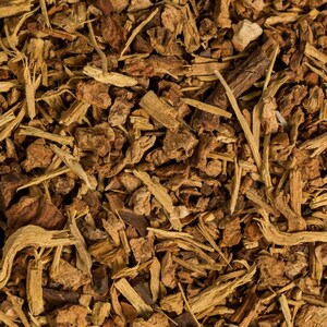 May include: Close-up of a pile of dried, brown, and tan herbal tea ingredients.