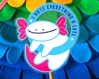 Può includere: Un adesivo con un axolotl bianco con branchie rosa e coda blu, che nuota in cerchio. L'axolotl sorride e l'adesivo dice "Odio tutto molto!" in un cerchio bianco con contorno nero.