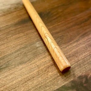 Straight rolling pin that is non tapered sometimes called a dowel rolling pin