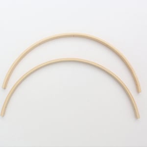 May include: Two wooden hoops, one slightly larger than the other, are stacked on top of each other. The hoops are made of natural wood and have a smooth finish.