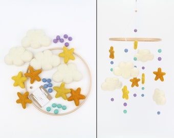 May include: A DIY felt baby mobile kit with white clouds, yellow stars, and colourful felt balls. The kit includes a wooden hoop, string, and all the felt pieces needed to create a custom mobile.