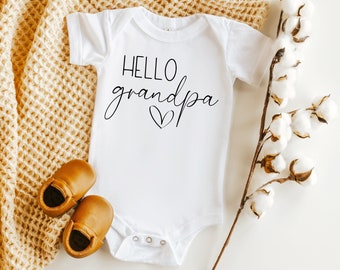 May include: White baby onesie with the text "HELLO grandpa" in black script with a small heart.
