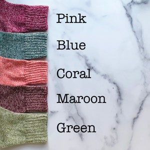 May include: Five different colored knitted fabric swatches, labeled "Pink", "Blue", "Coral", "Maroon", and "Green".