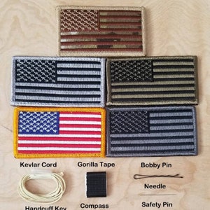 May include: A set of survival gear with a variety of tools, including a compass, handcuff key, bobby pin, needle, safety pin, gorilla tape, and kevlar cord. The tools are arranged on a wooden surface with five American flag patches in the background.