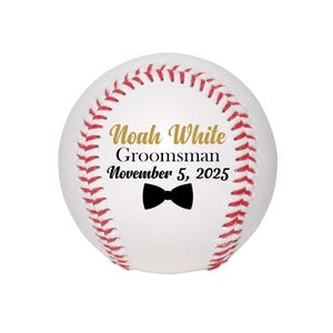 May include: White baseball with red stitching and a black bow tie. The text "Noah White Groomsman November 5, 2025" is printed in black and gold.