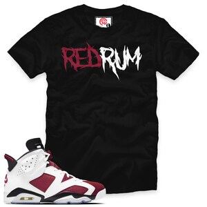 May include: Black t-shirt with "RED RUM" printed in white and red lettering.  A pair of white and burgundy sneakers with black accents.