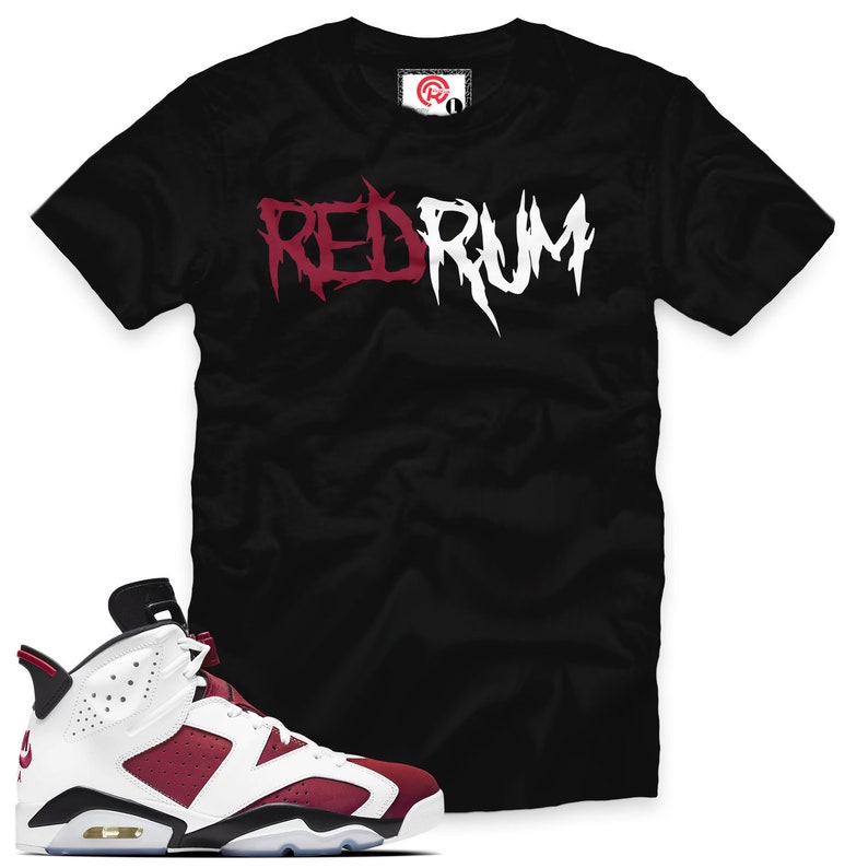 May include: Black t-shirt with "RED RUM" printed in white and red lettering.  A pair of white and burgundy sneakers with black accents.