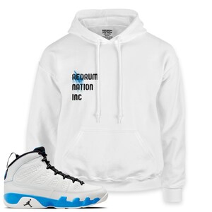 May include: White hoodie with "REDRUM NATION INC" printed on the front, paired with white and blue Air Jordan 9 Retro sneakers.