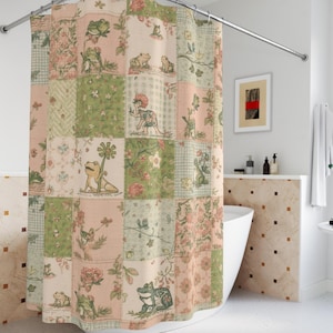 May include: A patchwork shower curtain featuring a repeating pattern of frogs, flowers, and foliage in shades of green, pink, and cream. The curtain is hanging from a curved metal rod, adding a touch of whimsy to the bathroom decor.