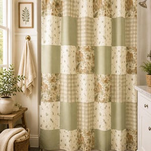 May include: A shower curtain featuring a patchwork design of alternating squares in sage green, cream, and a patterned print with illustrations of wild cats and foliage. The curtain hangs from a black rod with rings and covers a bathtub area.