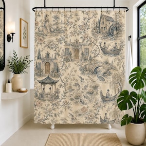May include: A shower curtain featuring a beige background with a repeating toile pattern in blue and brown tones. The design depicts pastoral scenes, including a water mill, a stone bridge, koi fish in a pond, and figures in small boats.