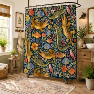 May include: A dark blue shower curtain featuring a repeating pattern of yellow and green crocodiles, various colorful fish, pink birds, and orange and yellow flowers. The fabric hangs from a curved rod with metal rings, displaying a dense botanical design.