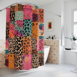 May include: A colorful shower curtain with a patchwork design. The curtain features squares of various animal prints in shades of pink, orange, black, and teal. The curtain hangs from a curved, silver-colored rod.