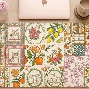 May include: A decorative desk mat featuring a patchwork design with cat portraits, oranges, lemons, and floral patterns in shades of cream, orange, pink, and green. The mat is rectangular and designed for a desk or workspace.
