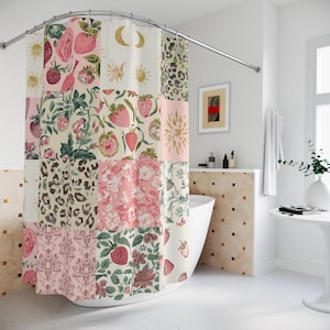 May include: A patchwork shower curtain featuring a variety of patterns including strawberries, floral designs, leopard print, and celestial motifs. The color palette includes pink, green, cream, and gold accents. The curtain is hanging from a curved metal rod.
