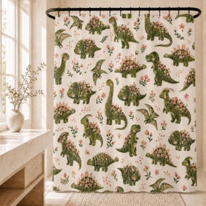 May include: A shower curtain featuring an all-over pattern of various green dinosaurs decorated with small pink and white flowers. The background is a light cream color, and the design includes multiple species of dinosaurs and floral sprigs.