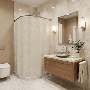 May include: A modern bathroom with a beige shower curtain featuring a leaf pattern. The room includes a wooden vanity with a silver sink, a mirror, and a small plant. The walls and floor are marble.