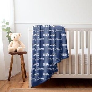 May include: A navy blue baby blanket with the names "Henry James" repeated in white text.
