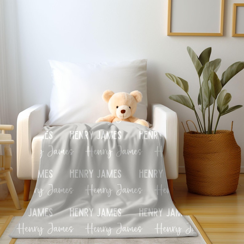 May include: A gray fleece blanket with the names "Henry James" repeated in white text.
