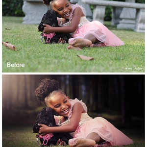 May include: A young girl with curly hair is laughing while hugging a black dog. The girl is wearing a pink dress and the dog is wearing a pink collar with a sparkly charm. They are both lying on green grass.