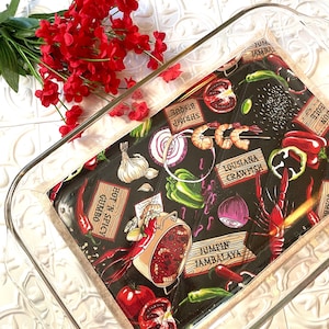 May include: A black and white fabric with a Cajun food theme. The fabric features images of crawfish, shrimp, tomatoes, peppers, garlic, onions, and a pot of gumbo. The fabric also has text that says "Hot 'n Spicy Gumbo", "Shrimp Bisque", "Jumbin' Jambalaya", and "Louisiana Crawfish".