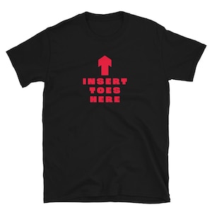 May include: A black short-sleeved t-shirt featuring a red upward-pointing arrow graphic centered above the red text that reads INSERT TOES HERE. The shirt has a crew neckline and a standard fit, displaying a bold, high-contrast design on the front.