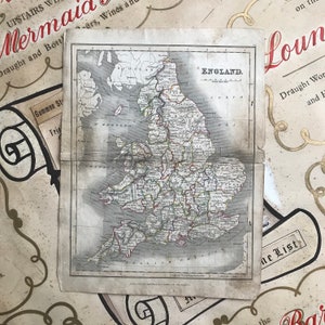 May include: An antique map of England, printed on aged paper with a faded brown colour. The map shows the counties of England with their names and borders. The map is titled "ENGLAND."