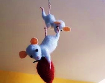 White mice in felted wool stitched by hand.
