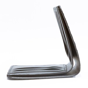 May include: A black leather wallet with multiple card slots and a fold-over closure.