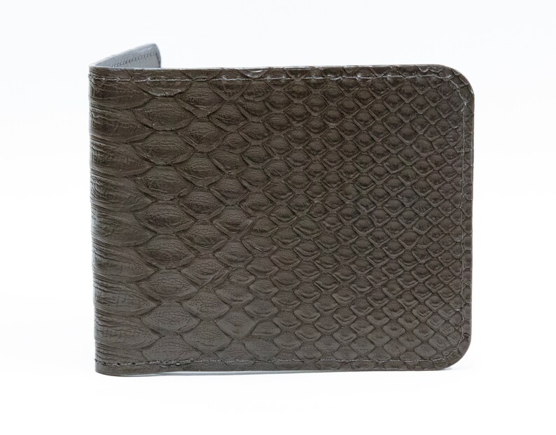May include: A dark gray leather wallet with a snakeskin pattern.