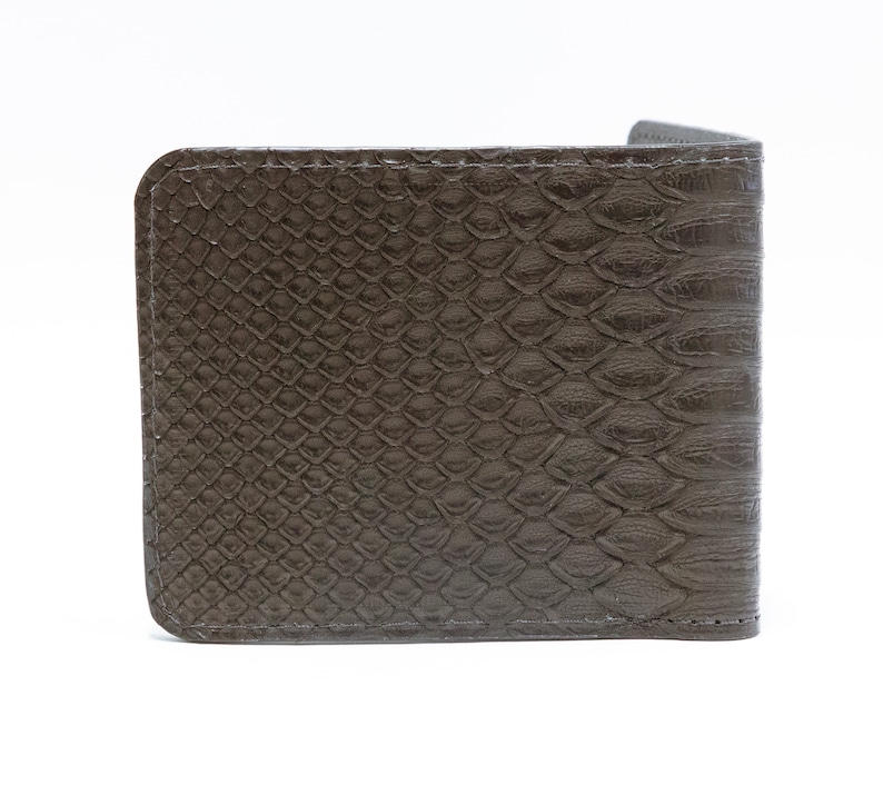 May include: A brown leather wallet with a snakeskin pattern.