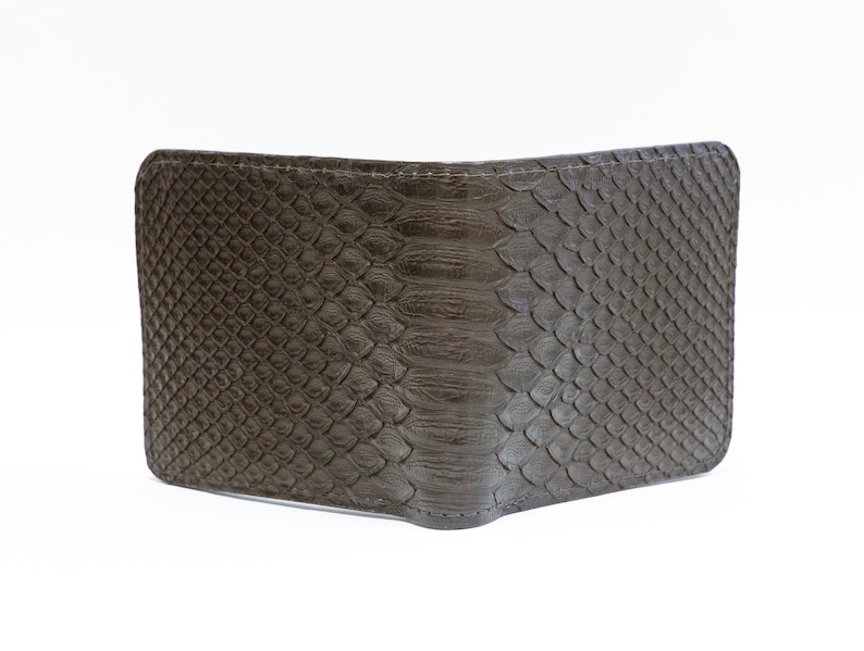May include: A brown leather wallet with a snakeskin pattern.