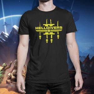 May include: Black t-shirt with a yellow graphic of a skull and the text "HELLDIVERS" with four yellow bombs underneath.