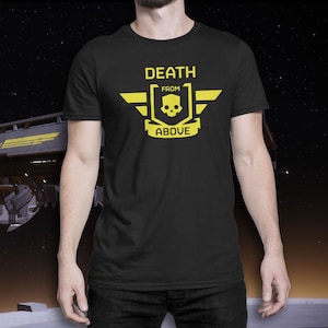 May include: Black crew neck t-shirt with a yellow graphic. The design includes a skull within a shield, wings, and the text "DEATH FROM ABOVE".