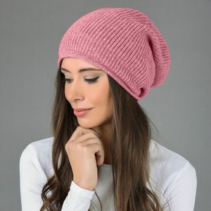 May include: A pink slouchy beanie hat made of soft knit fabric. The hat is folded down at the brim and has a relaxed, casual look.