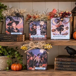 May include: Four square wooden blocks decorated with Halloween-themed illustrations of witches, ghosts, and pumpkins. Each block features text including Resting witch face, Ghouls just want to have fun, My broomstick runs on wine, and Drink up witches.