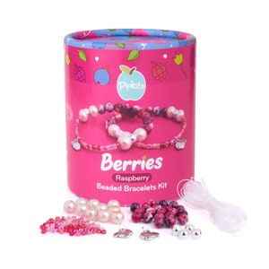 May include: A pink and white beaded bracelet making kit with a pink cylindrical box that says "Berries Raspberry Beaded Bracelets Kit". The kit includes pink and white beads, a clear elastic string, and silver charms.