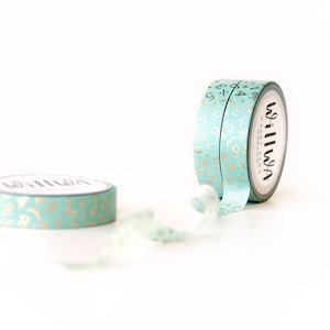 May include: Two rolls of washi tape with a teal background and gold foil numbers and symbols. The tape is labeled "Washi" on the side.