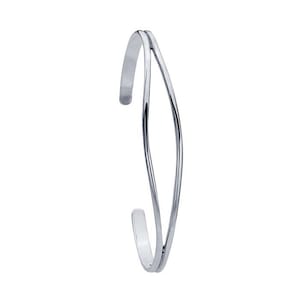 May include: A silver-colored open cuff bracelet. The bracelet has a minimalist design, with two parallel, curved bands that meet at the ends. The bands are smooth and shiny, reflecting light. The overall style is modern and elegant.