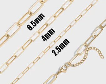 May include: Gold-colored chain necklaces in various sizes: 6.5mm, 4mm, and 2.5mm. The chains are displayed diagonally, showcasing their elongated link design. One chain features a clasp and an extender chain.