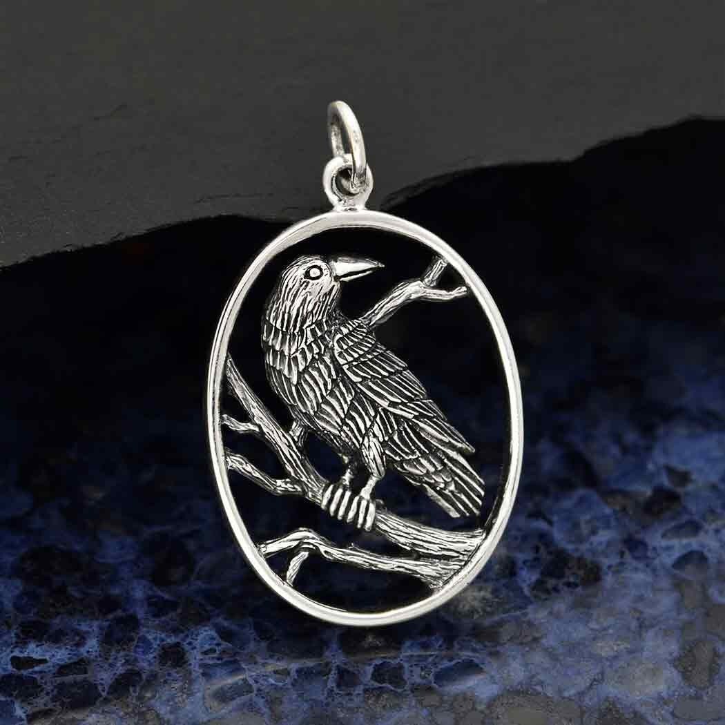 Sterling silver raven pendant in oval frame 29x18mm