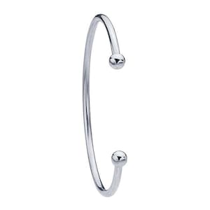May include: A silver bangle bracelet with two small round balls at the ends.