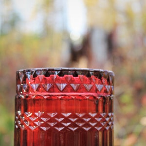 Beeswax candle in vintage style colored glass jar with wooden wick Wine