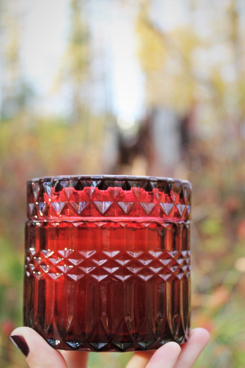 Beeswax candle in vintage style colored glass jar with wooden wick Wine