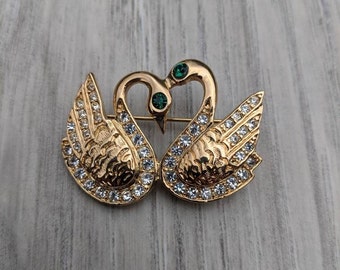 Gold Tone Metal and Clear and Emerald Green Rhinestone Pair of Swans Brooch