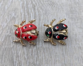 Pair of Red, Black, and White Enamel. Emerald Green Rhinestone, and Gold Tone Metal Ladybug Brooches