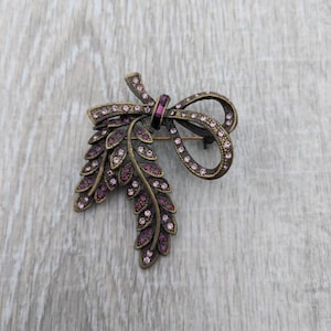Lilac and Amethyst Colored Rhinestone and Bronze Tone Metal Ribbon with Cascading Laurel Branches or Feathers Brooch