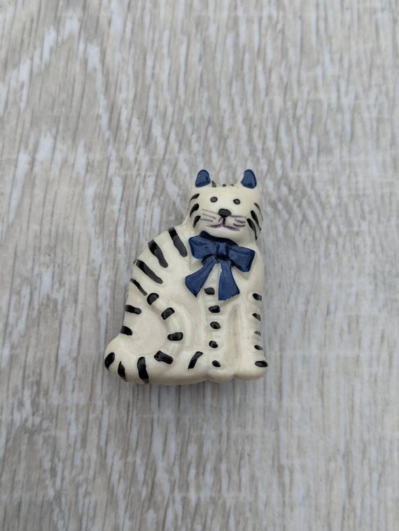 White Resin Cat with Black Stripes and a Navy Blu… - image 1