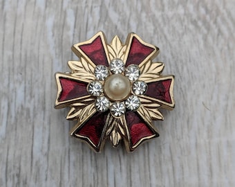 Small Midcentury Heraldic Ruby Red Enamel, Rhinestone, Faux Pearl, and Gold Tone Metal Sunburst Shield Brooch